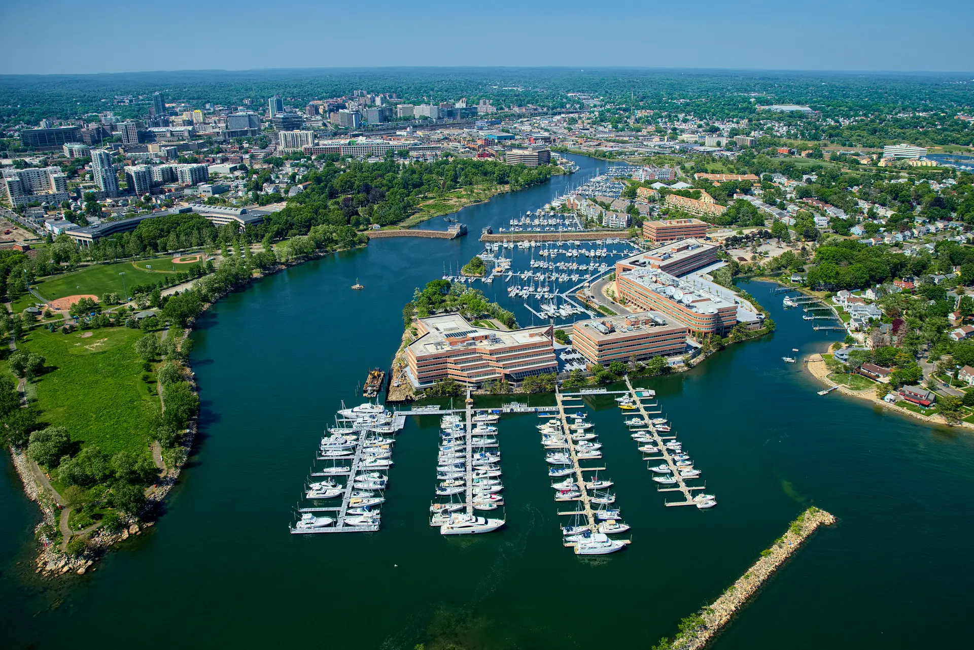 Stamford Harbor's marinas from the air, with the South End and the downtown Stamford skyline behind